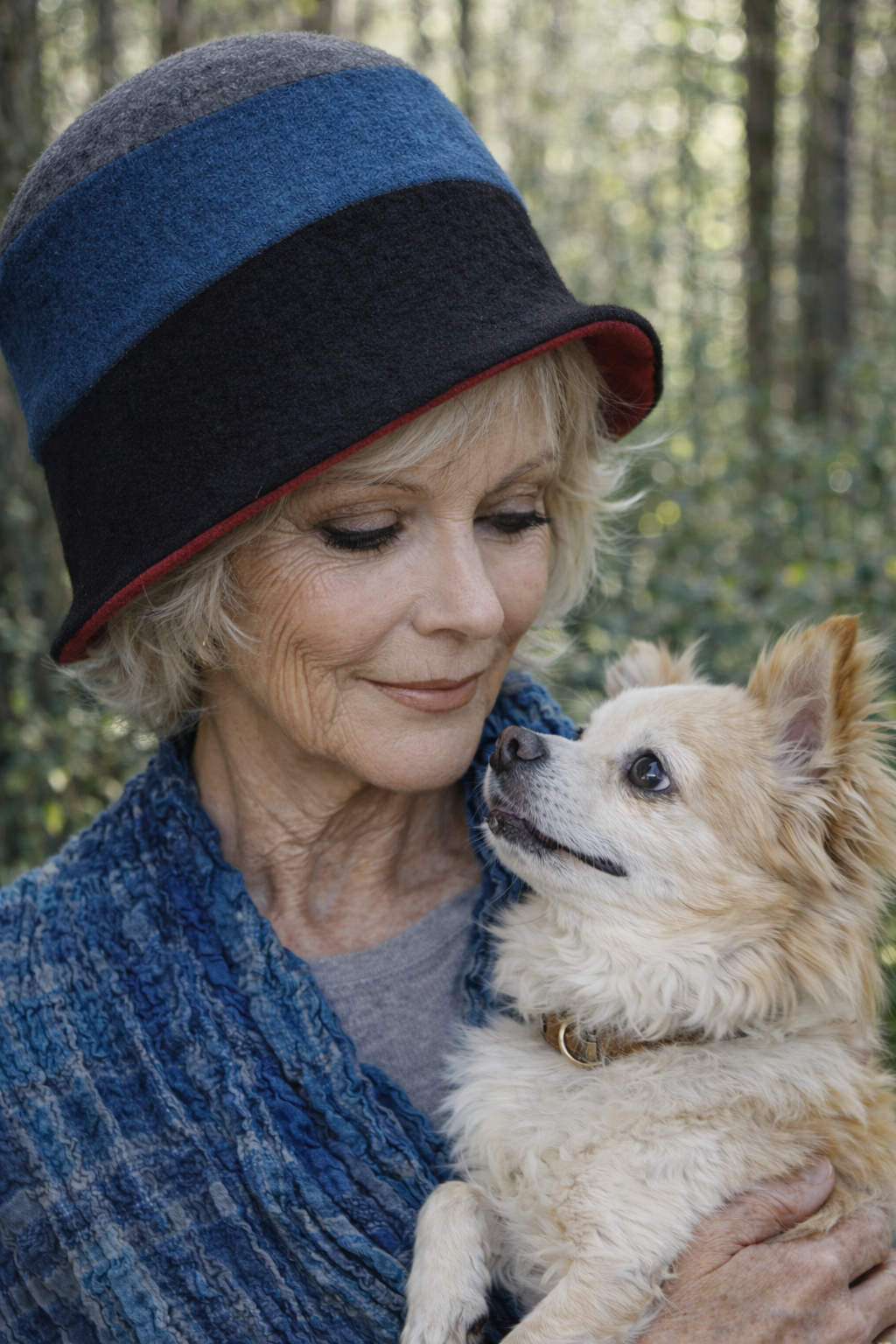 Frau mit Hund trägt einen Filzhut  im Wald 